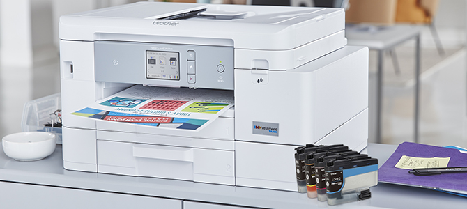 Brother's MFC-J4535DW inkjet printer on a desk, with ink cartridges